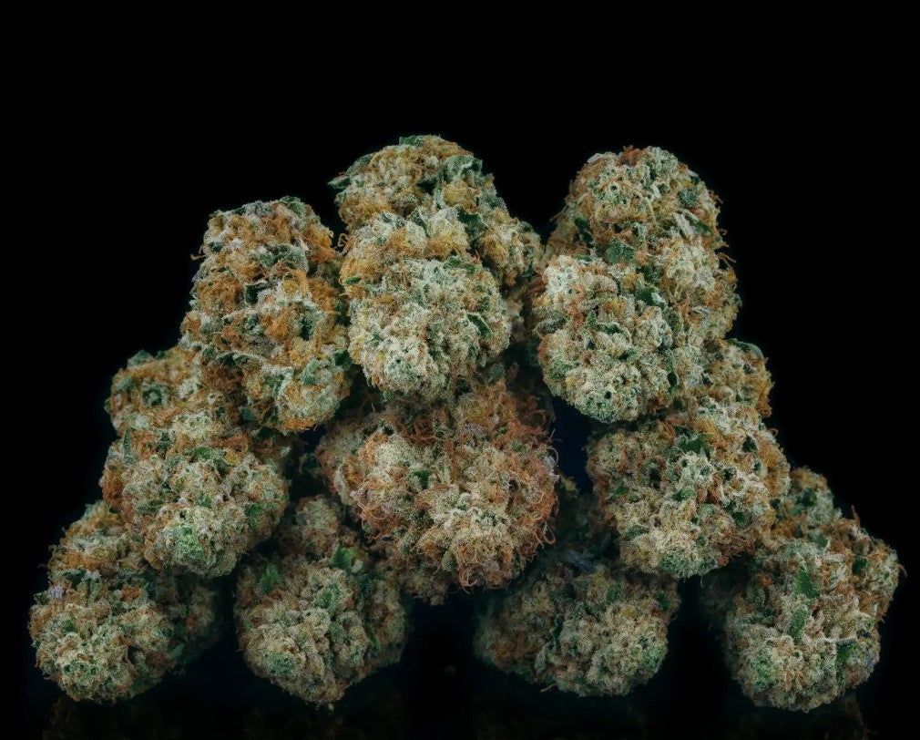 Close-up of a cluster of cannabis buds on a black background