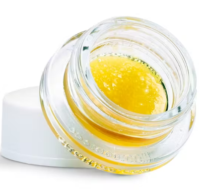 Mac and Cheese live resin in a clear jar with a white lid on a white background