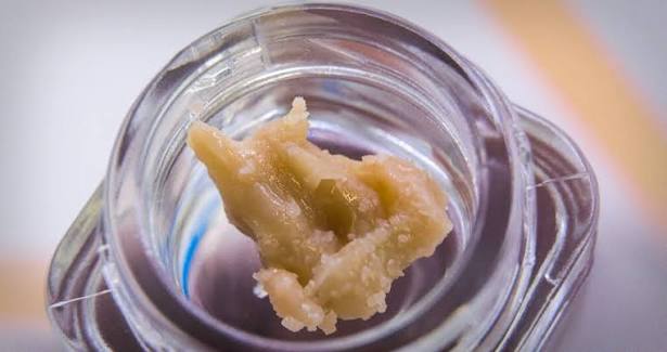 Close-up of a clear glass jar with unicorn poop rosin.